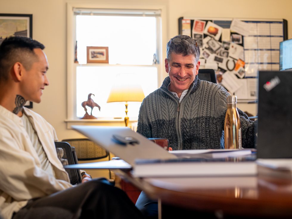 Two men talking in an office setting