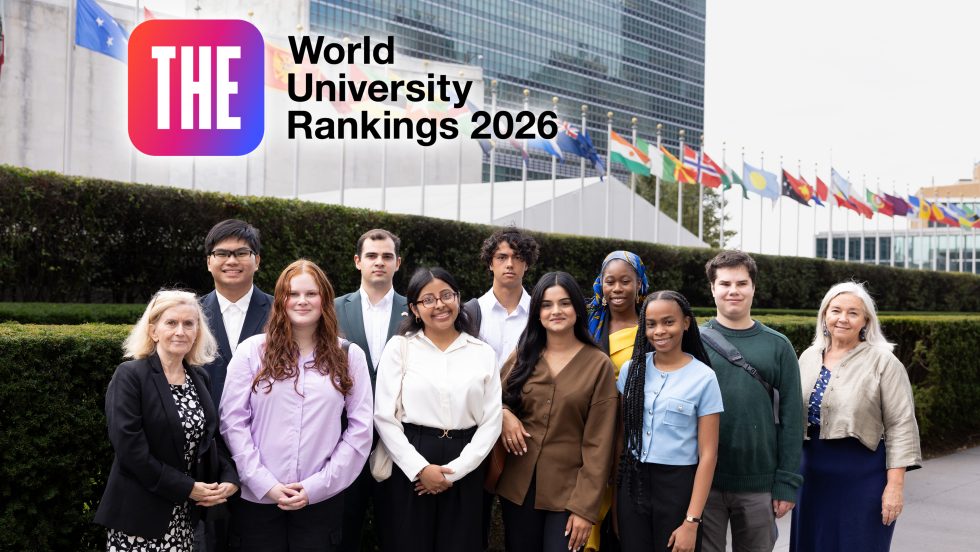 A group of nine Adelphi students and two faculty members stand in front of the United Nations headquarters in New York City.