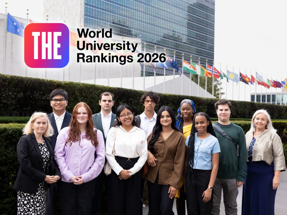 A group of nine Adelphi students and two faculty members stand in front of the United Nations headquarters in New York City.