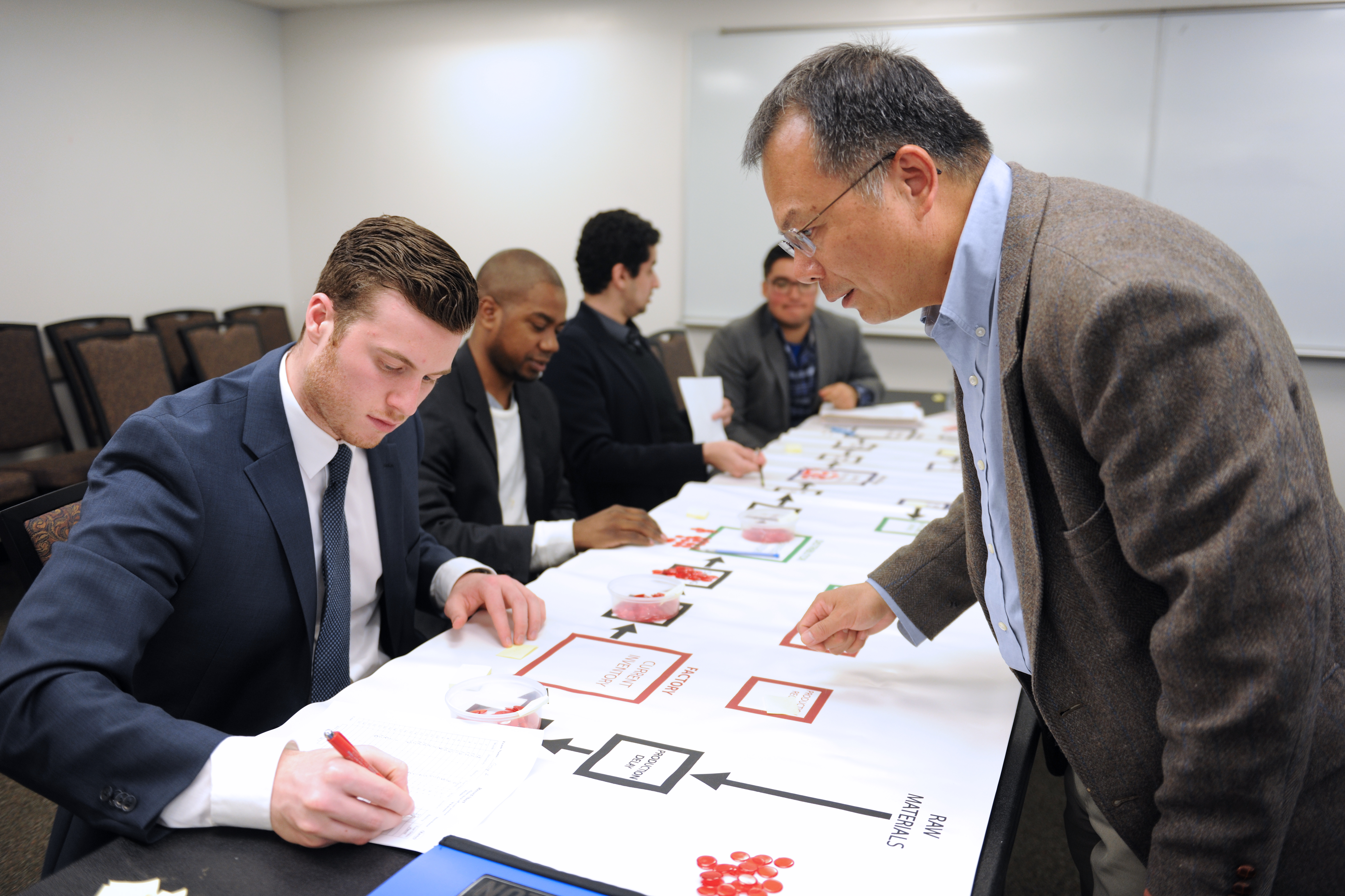 People in a classroom participating in a group activity.