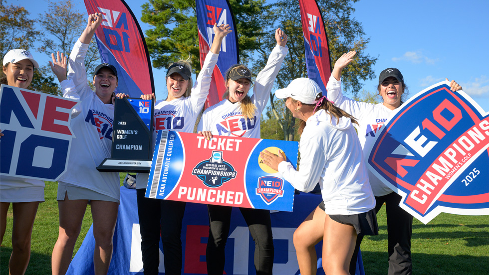 Six women golfers hold up signs and banners celebrating their win at the NE1o National Championship.