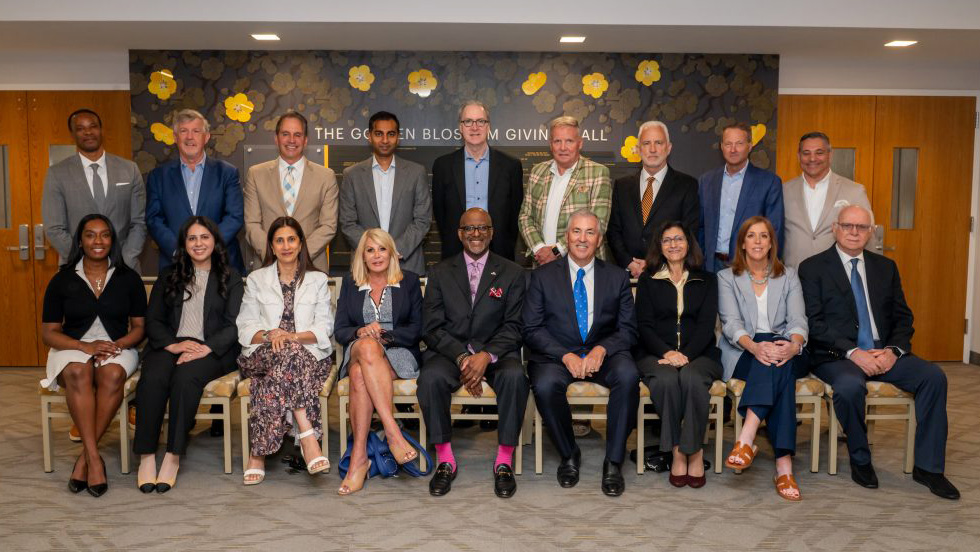 A large group of individuals, both men and women, are gathered for a formal portrait of our Board of Trustees.