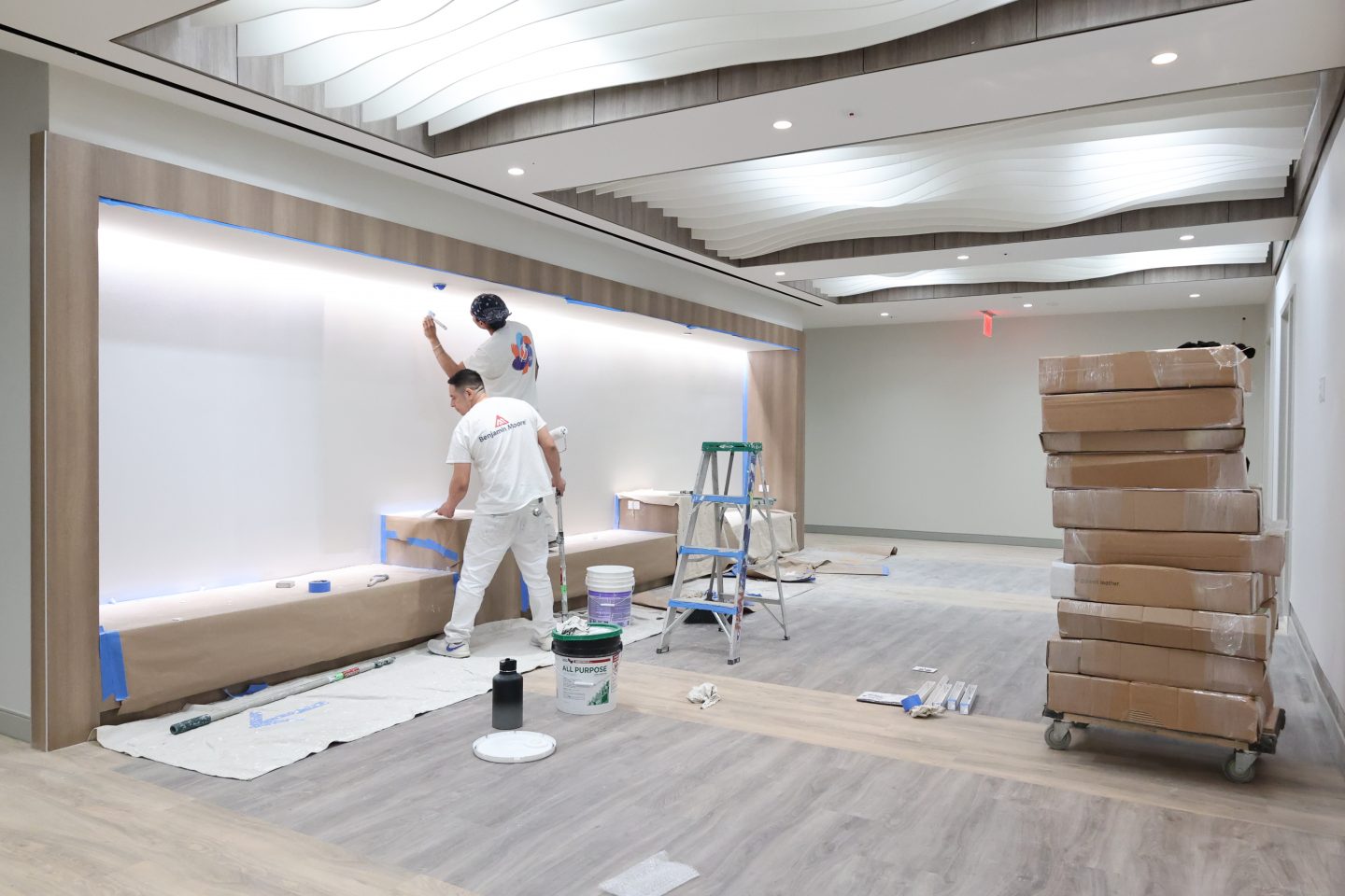 Adelphi Manhattan Center 2025 renovation progress: Overhead lighting, light wood and open spaces