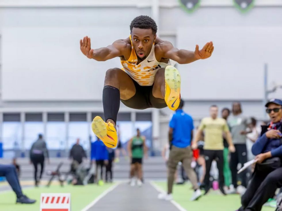 Jabari Holder mid-air during a long-jump