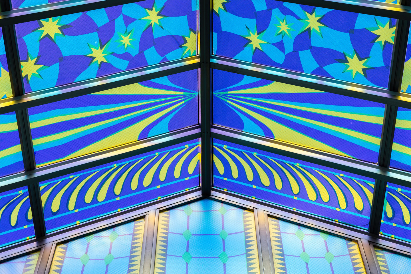 Looking up at the artwork, which features stars and rays of yellow against blue and purple fields