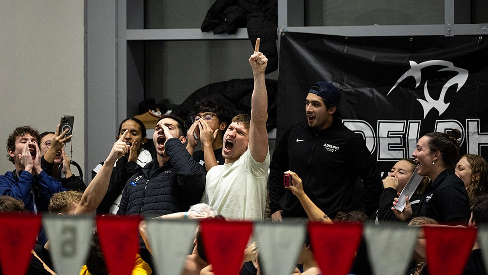 Two-time NE10 breaststroke medalist Andrew Kravtsov shows his Panther spirit alongside teammates.