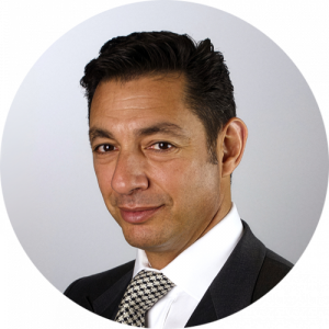 Headshot photo of a man in a business suit. 