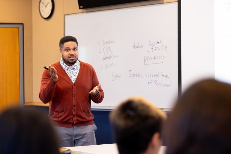 Professor Chris Davis teaching in the classroom for the African, Black and Caribbean Studies program.