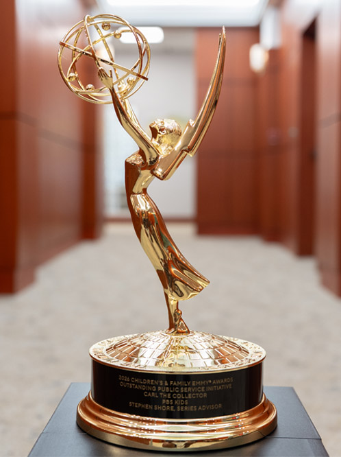 A closeup of the Emmy Award, which depicts a winged woman holding a model of an atom with outstretched arms.