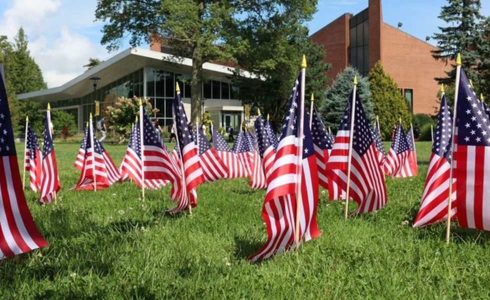 Adelphi University Center with a lawn full of American Flags as a memorial