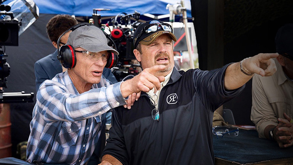 Robinson and Harris both point to action off screen, with film cameras behind them.