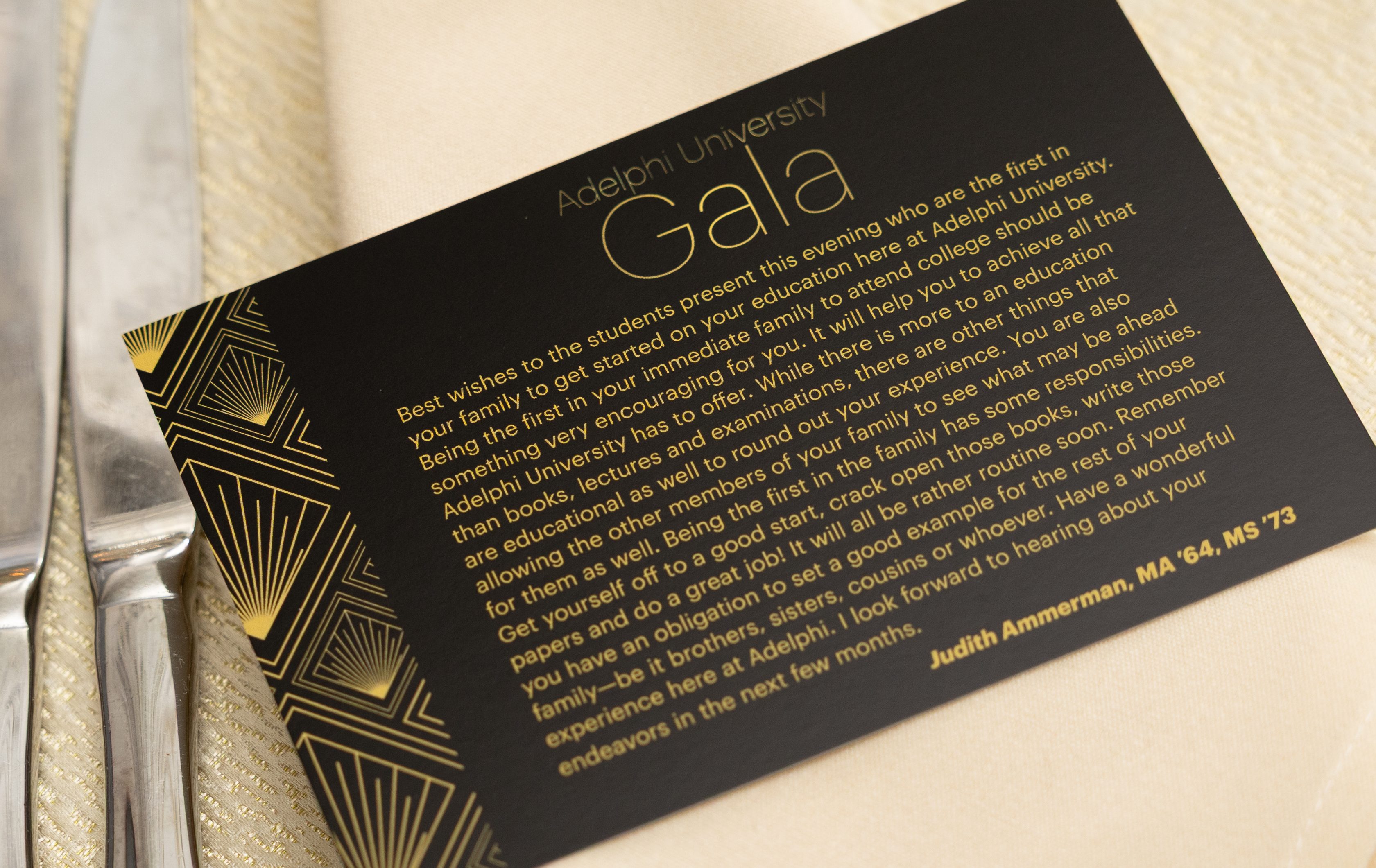 Black and gold gala table card featuring Judith Ammerman’s message encouraging first-generation students to embrace their education and set an example for their families.