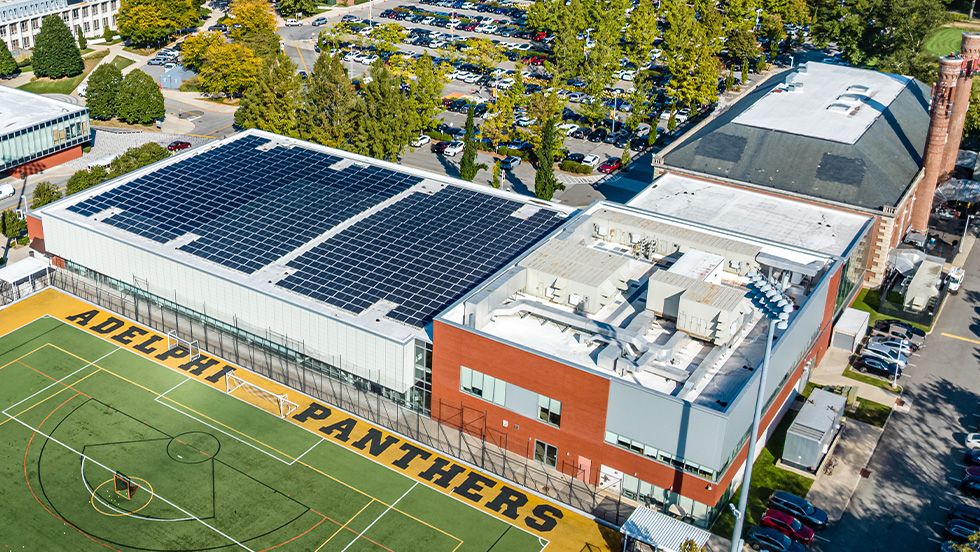 Overhead view of campus buildings, with bright blue solar panels on the Center for Recreation and Sports.